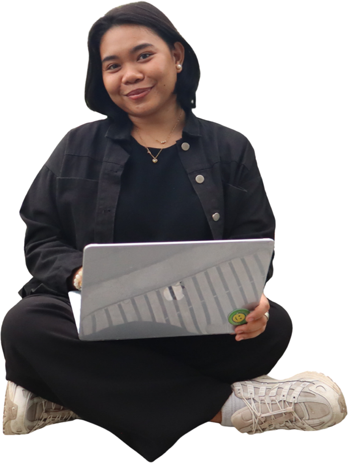 A Work Beyond Borders team member working on a laptop