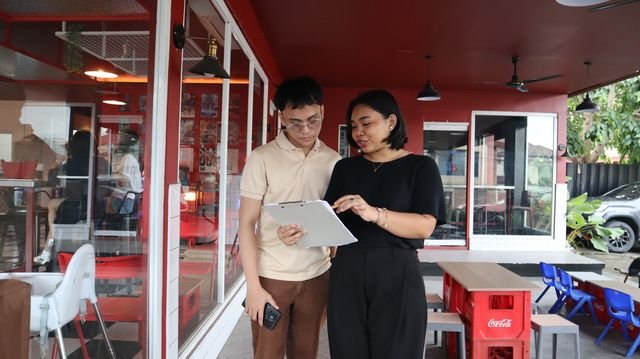 Two team members reviewing work on a tablet