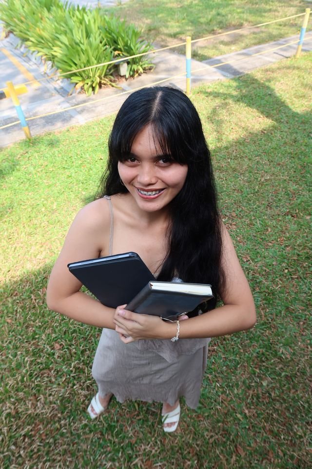 A team member with a tablet on the lawn