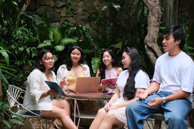 The team seated around a garden table