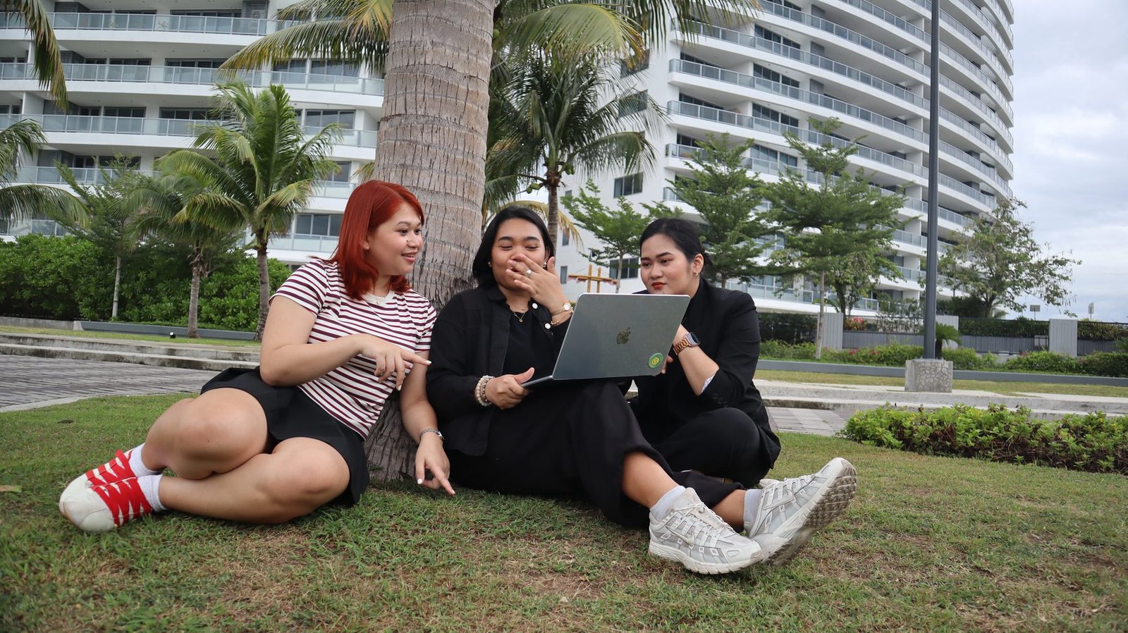 Three team members working together on the grass